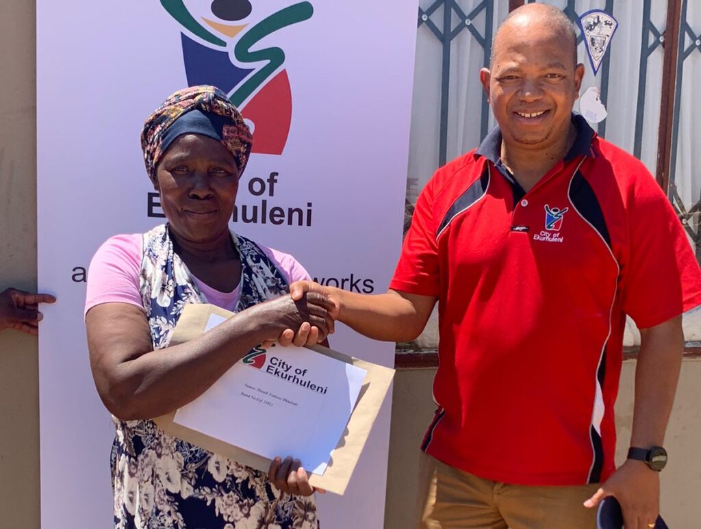 MMC for Human Settlements Ald. Masele Madihlaba congratulates Tsakane Dlakude after receiving her title deed.